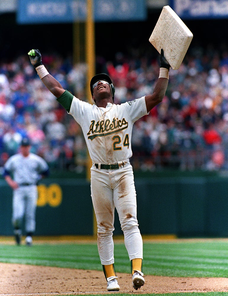 Rickey Henderson raises third base after breaking stolen base record