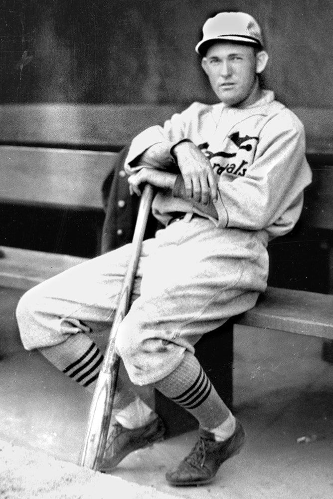 Rogers Hornsby seated in dugout