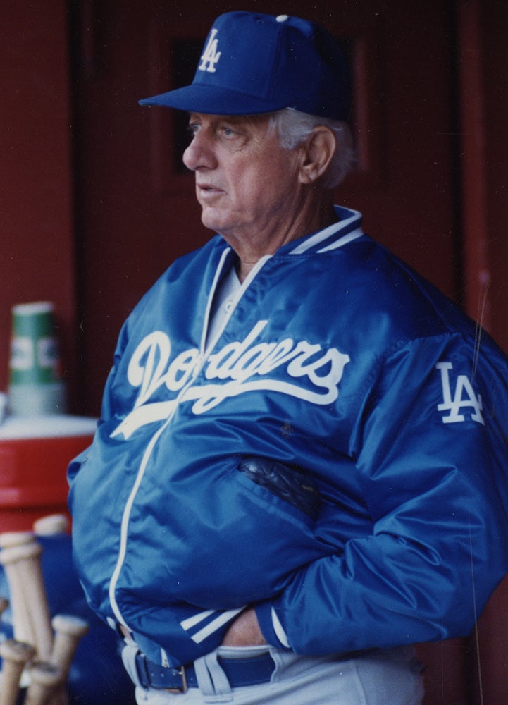 Tommy Lasorda wearing Dodgers jacket in dugout