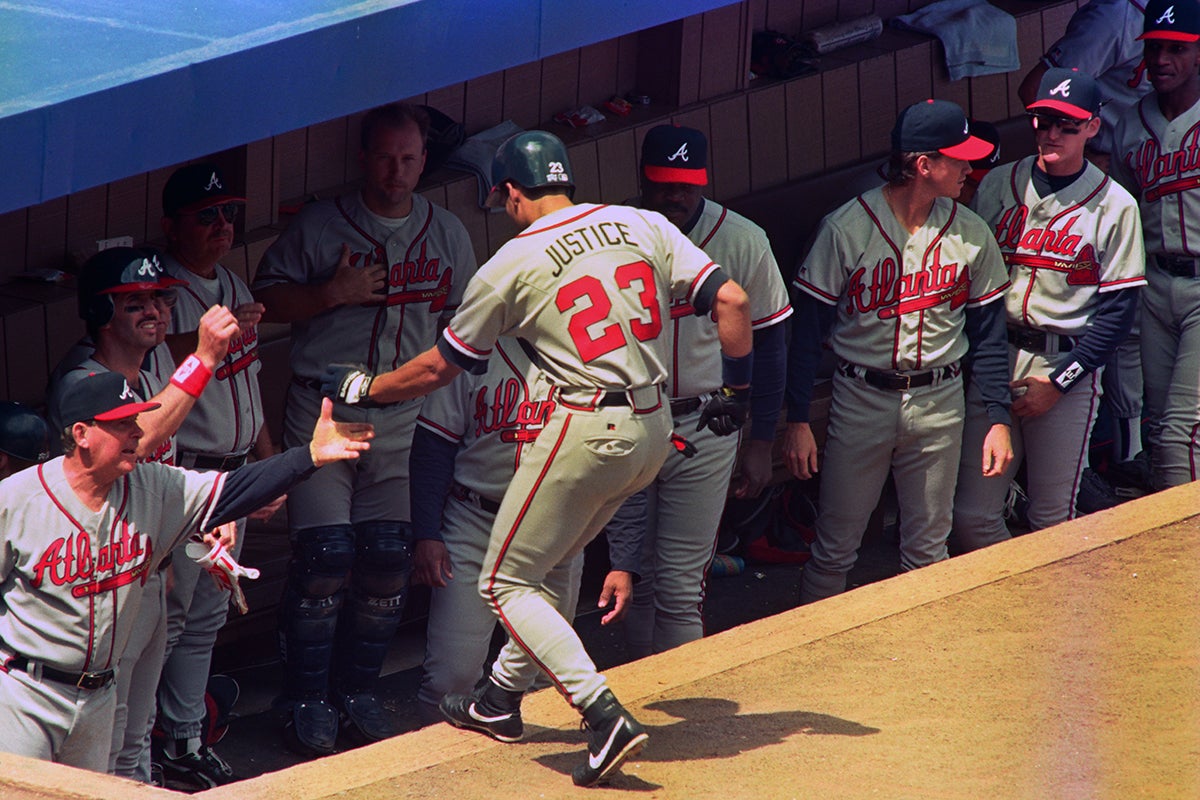 David Justice high fives teammates in Braves dugout