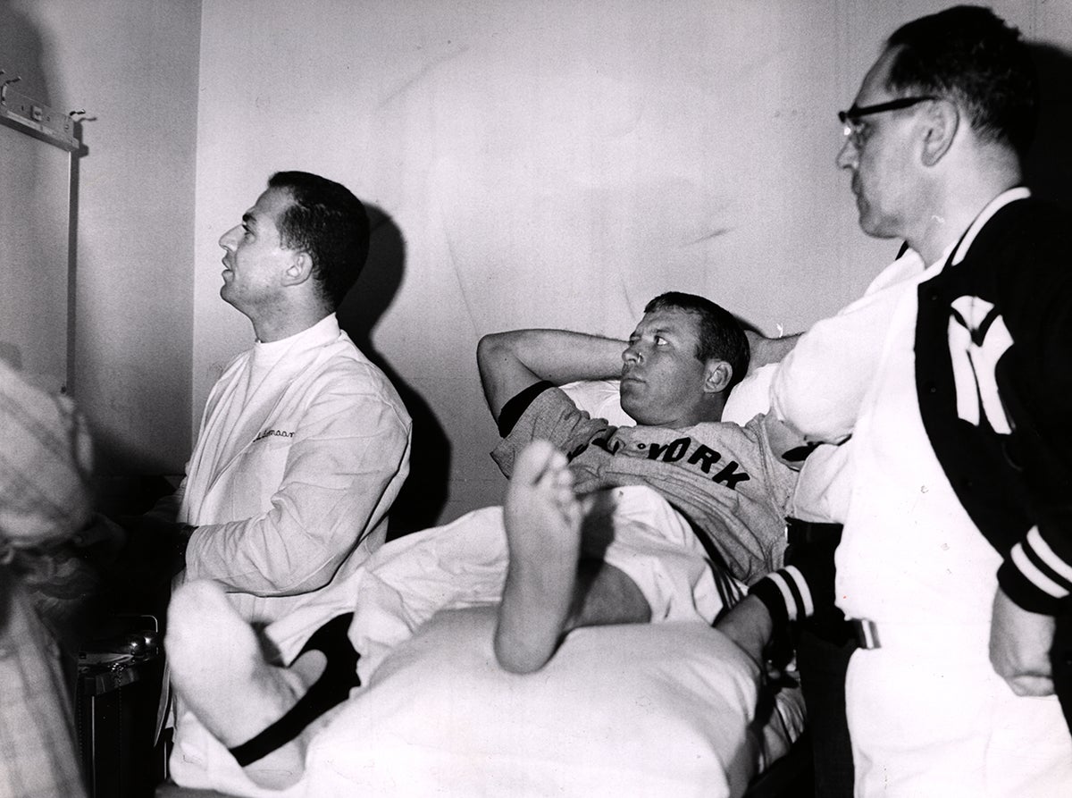 Mickey Mantle with legs wrapped in training room