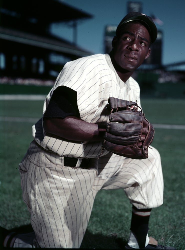 Posed portrait of Minnie Miñoso on one knee