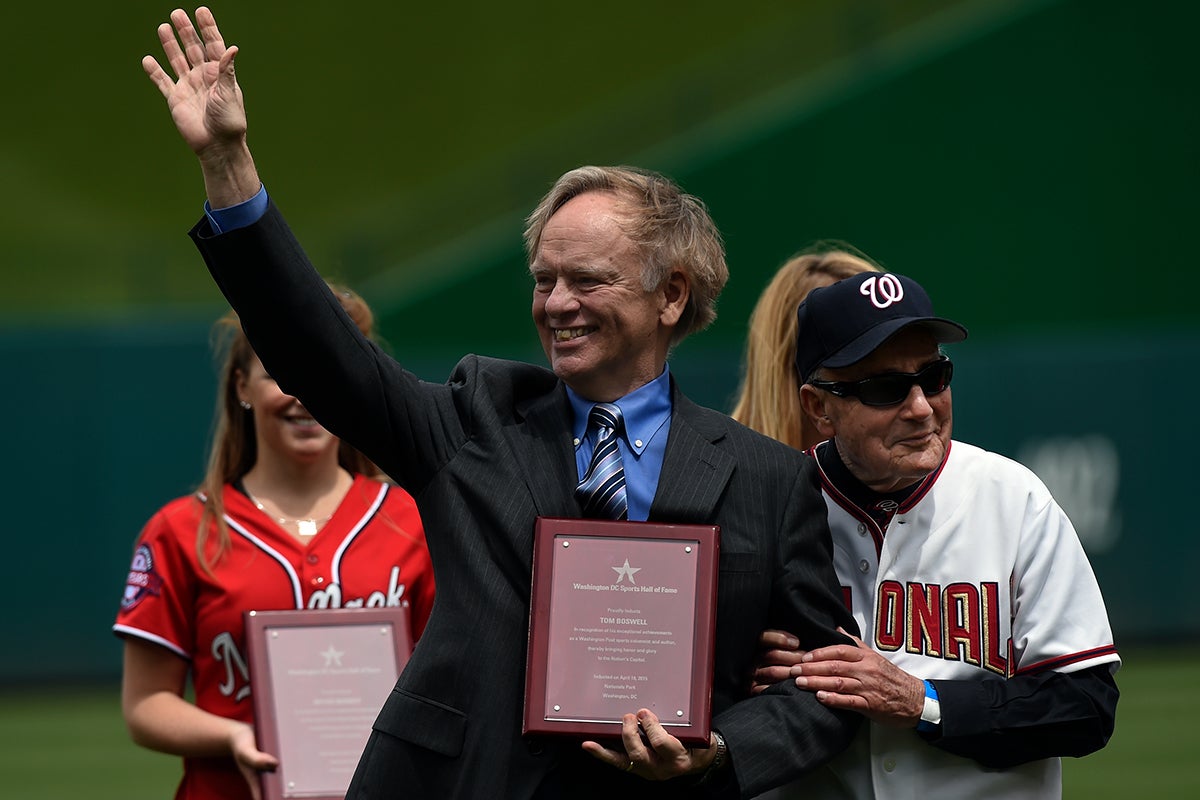 Thomas Boswell holds Washington D.C. Sports Hall of Fame plaque